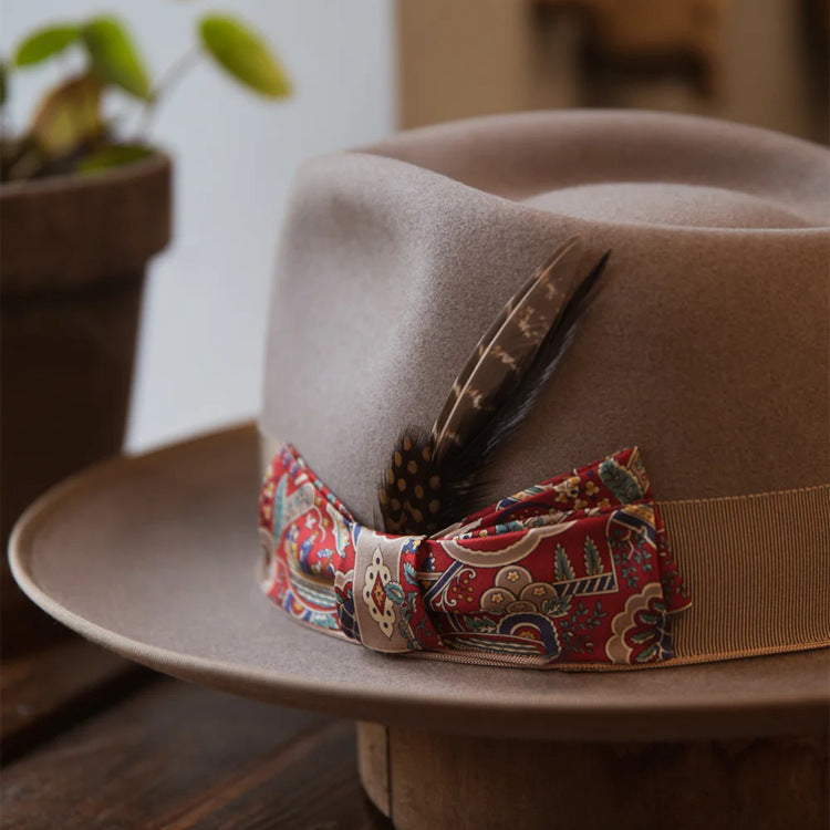 Stylish "V.I.P." Fedora featuring a decorative band and feather, perfect for timeless sophistication and elegance.